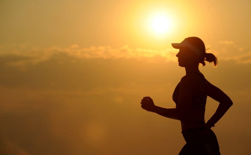 Woman jogging and getting exercise at sunrise